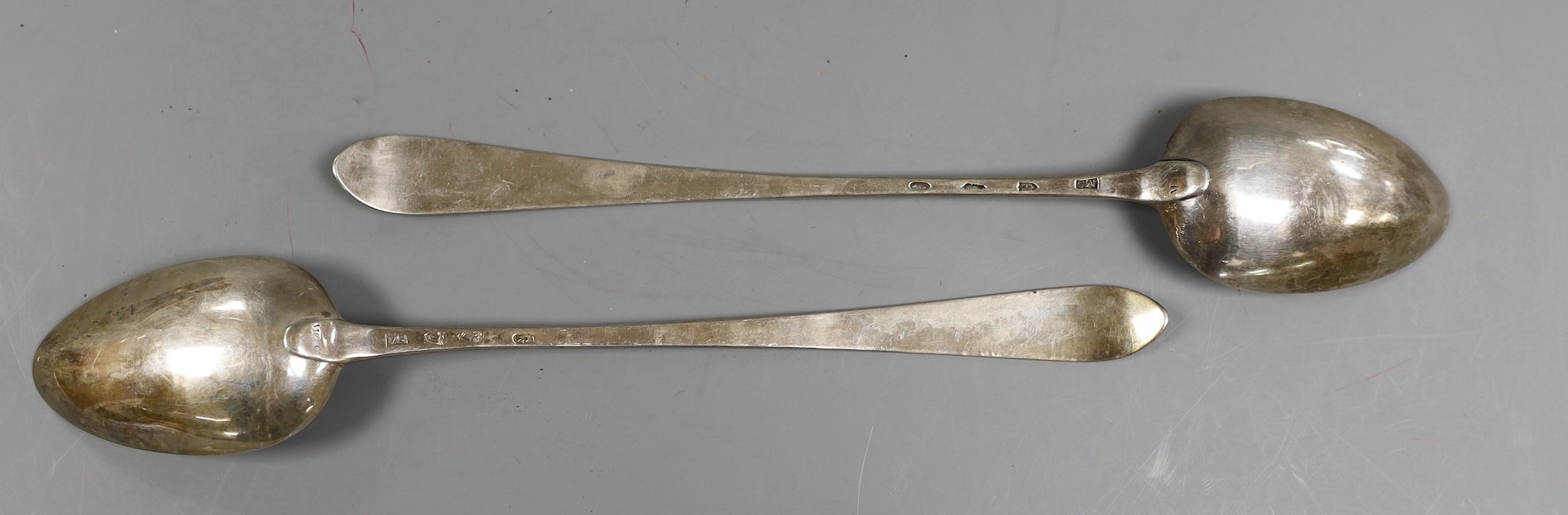 A pair of George II Irish silver bright cut engraved basting spoons, Michael Smith, Dublin, 1754 & 1757, 31.8cm, 6.3oz.